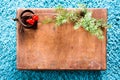 Box with wooden texture and fir tree on fluffy blue carpet background. Top view copy space Royalty Free Stock Photo