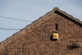 Newly installed alarm system and box seen attached to the outside wall of a home.