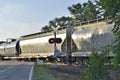 Boxcars and oil tanks at crossing Royalty Free Stock Photo