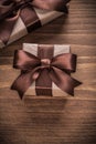 Boxed present containers with brown ribbons on vintage wooden bo Royalty Free Stock Photo