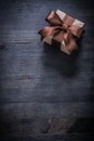 Boxed present with tied bow on vintage wood board copyspace