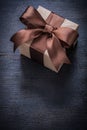 Boxed present tied bow on vintage wood board top view