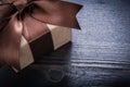 Boxed present with tied bow on vintage wooden surface