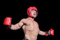 Boxer with arms outstretched against black background Royalty Free Stock Photo