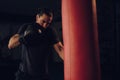 Boxer hitting the heavy bag with left hook