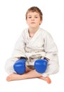 Boxer boy in white dress and blue boxing gloves Royalty Free Stock Photo