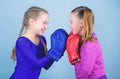 Boxer children in boxing gloves. Girls cute boxers on blue background. Friendship as battle and competition. Pass boxing