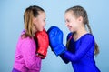 Boxer children in boxing gloves. Girls cute boxers on blue background. Friendship as battle and competition. Pass boxing