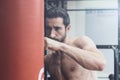 Boxer exercising with a punching bag at the gym Royalty Free Stock Photo