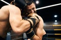 Boxer getting hit in the face while holding his opponent