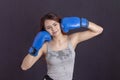 Boxer girl in gloves smiles in gray t-shirt Royalty Free Stock Photo