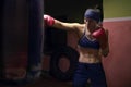 A boxer girl wearing red gloves and a bandana Royalty Free Stock Photo