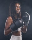 Boxer gloves, woman and portrait on black background for sports, strong focus or mma training. Female boxing, champion