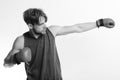 Boxer makes hits and punches as training. Athlete with leather box equipment isolated on white background. Boxing and Royalty Free Stock Photo