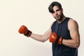 Boxer makes hits and punches as training. Man with bristle and serious face wears boxing gloves. Boxing and sports Royalty Free Stock Photo