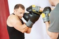 Boxer man at boxing training with punch mitts Royalty Free Stock Photo