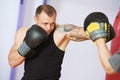 Boxer man at boxing training with punch mitts Royalty Free Stock Photo