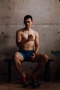 Boxer man sitting in gym room with low light Royalty Free Stock Photo