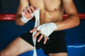 Boxer man is wrapping hands with boxing wraps