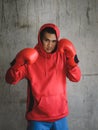 Boxer in red hood with wall grunge background. Royalty Free Stock Photo