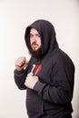 Boxer with a serious face with a huge beard. In the hood stands Royalty Free Stock Photo