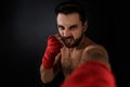 Boxer throwing a fierce and powerful punch. Royalty Free Stock Photo