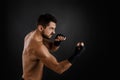 Boxer throwing a fierce and powerful punch. Royalty Free Stock Photo