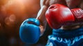 Boxer wearing blue and red boxing gloves, ready to strike in a warm-lit ring. Copy space. Concept of readiness, sports Royalty Free Stock Photo