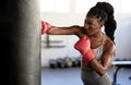 Boxer, workout and training girl with punching bag working on sports fitness, exercise and strength. Athlete, fighter or