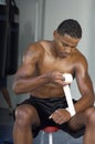 Boxer Wrapping His Hands In Gym