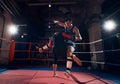 Boxers training kickboxing in the ring at the health club