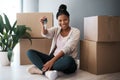 Boxes, black woman and homeowner with keys, to new home and happiness in home. Property, African American female and