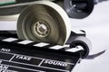Boxes with the camera films and cinema clapper on the table. Royalty Free Stock Photo