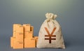 Boxes and chinese yen or japanese yuan money bag. The concept of trade in goods and production. Profit from trading. GDP economy. Royalty Free Stock Photo