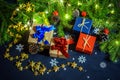 Boxes with gifts on the background of FIR branches, cones and garlands Royalty Free Stock Photo