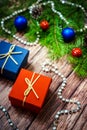 Boxes with gifts on the background of FIR branches, cones and garlands Royalty Free Stock Photo