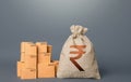 Boxes and indian rupee money bag. The concept of trade in goods and production. Profit from trading. GDP economy. Import export. Royalty Free Stock Photo