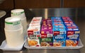 Shelf with boxes of instant oatmeal, corn flakes in various flavors.A quick healthy fast breakfast food offered in a bar