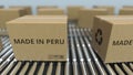 Boxes with MADE IN PERU text on roller conveyor. Peruvian goods related 3D rendering Royalty Free Stock Photo