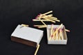 boxes and matches lie on a black background Royalty Free Stock Photo