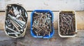 Boxes of old rusty metal screws on wooden background Royalty Free Stock Photo