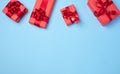 Boxes packed in red paper and tied with ribbon on a blue background, gifts Royalty Free Stock Photo
