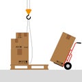 Boxes on a pallet are lifted with a crane hook. Royalty Free Stock Photo