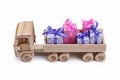 Wooden toy car with gifts in boxes in back. Copy space, isolated on white. Royalty Free Stock Photo