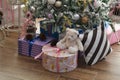 Boxes of presents under the green Christmas tree decorated with festive toys Royalty Free Stock Photo