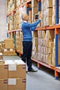 Boxes, tablet or man by shelf in warehouse for stock, inventory or logistics info for a delivery order in factory. Check