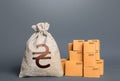 Boxes and ukrainian hryvnia money bag. Warehousing logistics. Business industry. Delivering. Profit from trading. GDP economy. Royalty Free Stock Photo