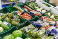 Moscow, Russia, 04/29/2020: Boxes with various vegetables in brightly colored packaging at a supermarket. Side view