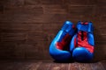 Boxing background with two gloves on the brown plank background. Royalty Free Stock Photo