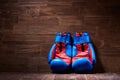 Boxing background with two gloves on the brown plank background. Royalty Free Stock Photo